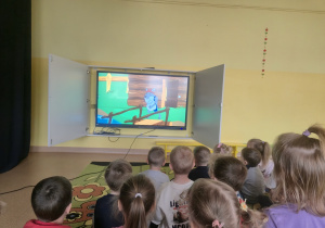 Dzieci oglądają bajkę "Wilk i siedem koźlątek"